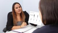 A woman holds up a chromosome mutation diagram.